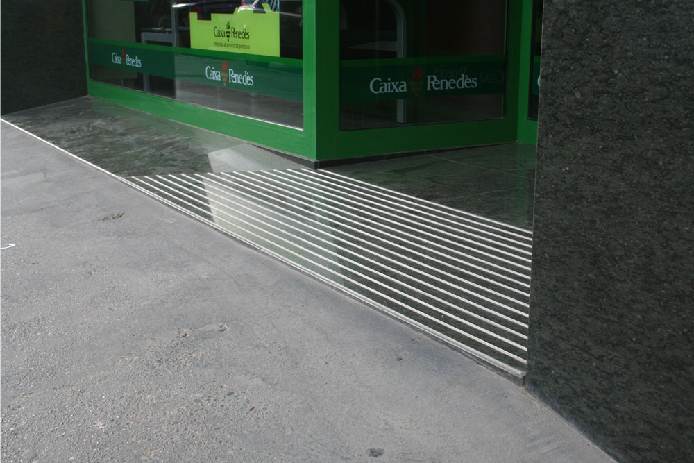 Rampa entrada oficina bancaria con bandas antideslizante de aluminio